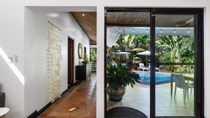 Un interior moderno con un ventanal que da a una zona de piscina al aire libre.