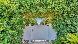 A gated entrance surrounded by lush greenery.