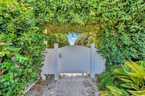 A gated entrance surrounded by lush greenery.