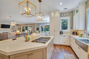 Enjoy meal preparation in this well-lit kitchen with a large island and gas stove.