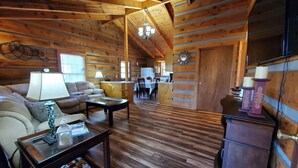 A log cabin interior with a living room, dining area, and kitchen. - Villa Bonita/ Private Mountain top Cabin on 7.5 Acres w/Hot Tub (Sevierville)