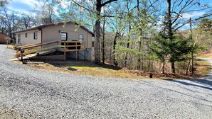 A cabin with a wooden deck and a gravel driveway. - Villa Bonita/ Private Mountain top Cabin on 7.5 Acres w/Hot Tub (Sevierville)