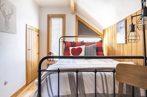 You'll "love" the cozy cabin feel of this room w/double bed.