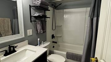 Combined shower/tub, hair dryer, towels, soap