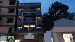 A building with a sign for 'PUNEST Hospitality A/C Rooms'. - Itsy Hotels Punest (Pune)