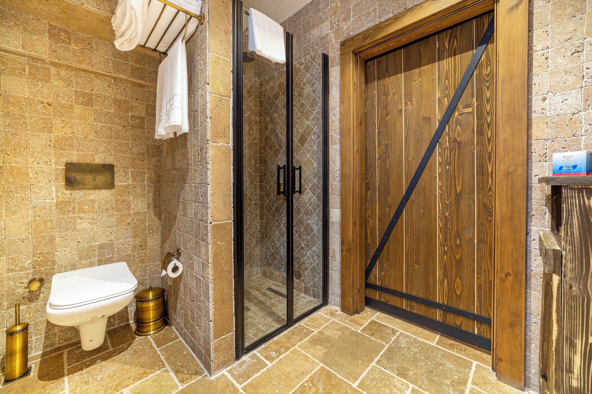 A bathroom with a toilet, bidet, and shower.