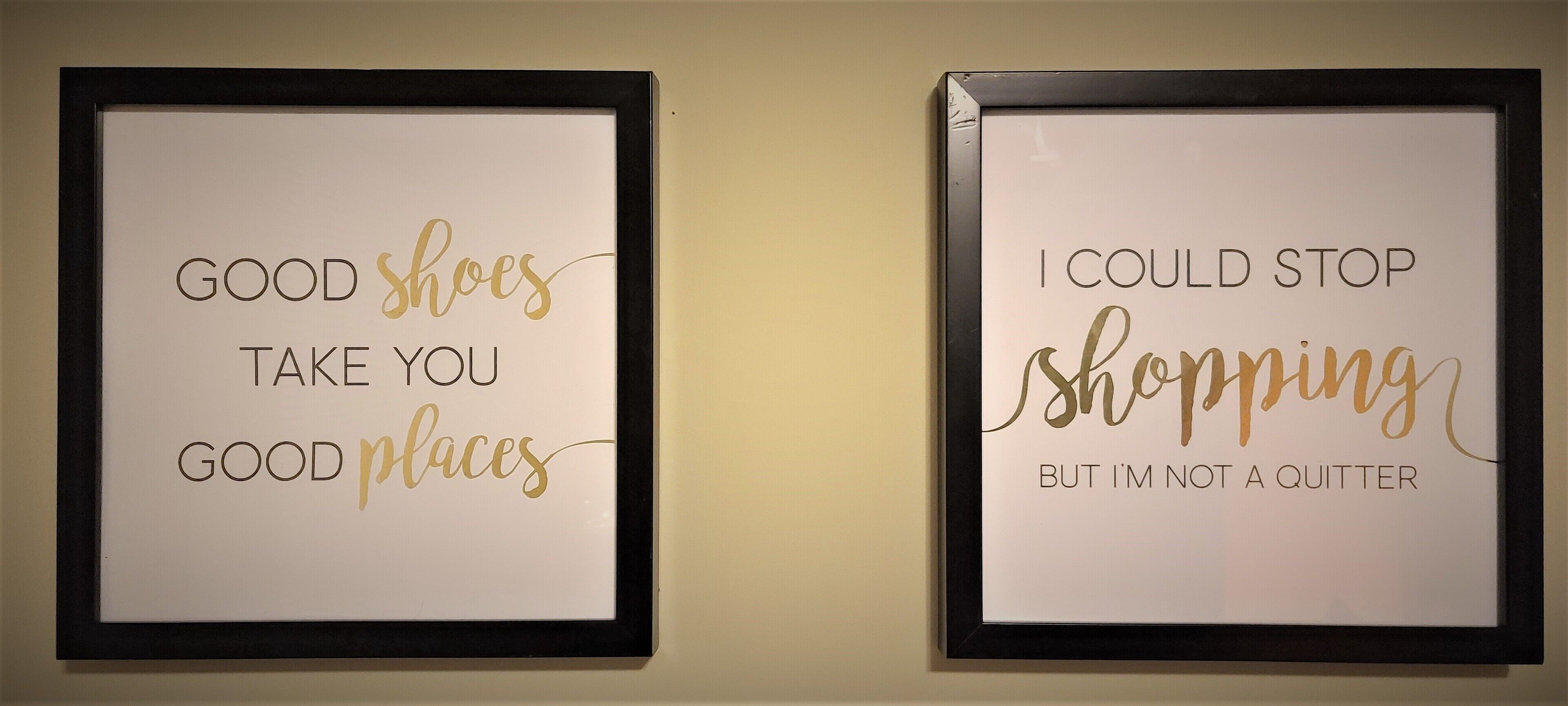 Two framed signs with motivational quotes on a wall.