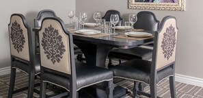 Enjoy meals with family and friends at this dining area, featuring a round table and comfortable chairs.