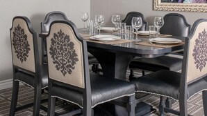 A dining table set for six with black chairs and beige cushions. - A fabulous vacation retreat just one block from the Las Vegas Strip. (Las Vegas)