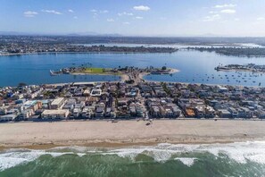 An aerial view of a coastal town with a beach, marina, and residential area. - Mission Beach Steps to Beach Remodeled Home with AC, fireplace, and Parking (San Diego)