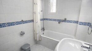 Ein Badezimmer mit einer Badewanne, einem Waschbecken und einer Toilette.