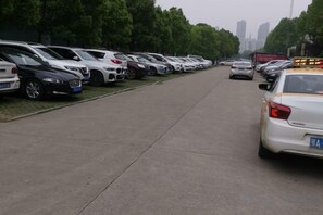 A parking lot with multiple cars parked in rows. - Jiutong Haiyuan International Hotel (Wuhan)