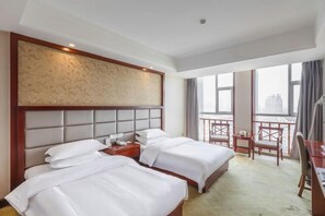 A hotel room with two beds, a desk, and a balcony with a city view. - Hongtai Hotel (Baofeng)