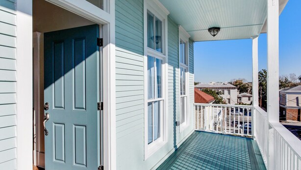 A covered porch with a view of the neighborhood. - High Style, Fun Decor, Awesome Location! 117D by Forsyth Park (Savannah)