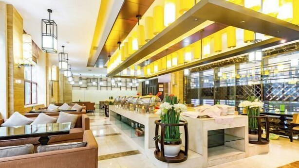 A modern hotel lobby with seating areas, a reception desk, and a glass partitioned bar area. - Shuixi Hotel (Qianxi)