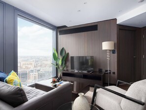A modern living room with a large window, a flat-screen TV, a coffee table, a sofa, and a lamp. - Lexicon, Angel by Interhome (London City)