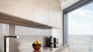 A modern kitchen with a large window, stainless steel appliances, and a bowl of lemons on the counter. - Lexicon, Angel by Interhome (London City)