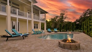 A pool area with lounge chairs and a fire pit. - Riverview Paradise, Sleeps 18, River, Pool/Spa, kayaks  (Alva)