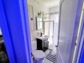 Combined shower/bathtub, towels, soap, toilet paper
