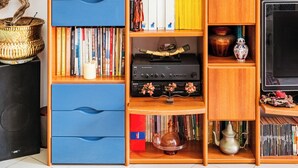 A room with a bookshelf, a TV, and decorative items.