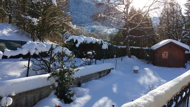 A wooden cabin surrounded by snow-covered trees and a clear sky. - Villa 130 m² near 3 valleys and spa (Salins-Les-Thermes)