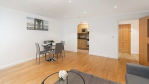 A modern apartment with a dining area, kitchen, and a living room. - Skyvillion Apartments - Barnet - Beautiful 2Bed Apartment with Balcony (New Barnet)