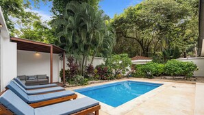 A poolside area with lounge chairs and a covered seating area. - 7 min walk to Surfing Paradise, Pool & Ocean Fun (Playa Grande)