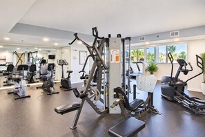 A gym with various exercise equipment, including treadmills, stationary bikes, and weight machines. - Gulfside 505 - Gulf Front, Community Pool, Hot Tub, Tennis, Basketball, Fitness! (Miramar Beach)