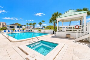 A swimming pool with lounge chairs and a gazebo. - Gulfside 505 - Gulf Front, Community Pool, Hot Tub, Tennis, Basketball, Fitness! (Miramar Beach)