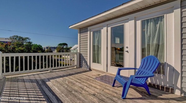 Relax on the covered porch with a comfortable Adirondack chair and enjoy the serene surroundings.
