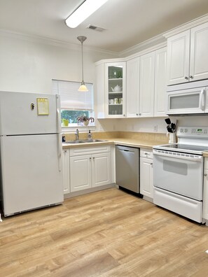 Enjoy cooking in this well-equipped kitchen with a double oven, microwave, and stainless steel appliances.