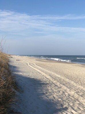 Enjoy a serene beach experience with calm seas and scenic views.