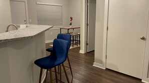 Enjoy meals in the kitchen with a sink and dining area featuring a table and two stools.