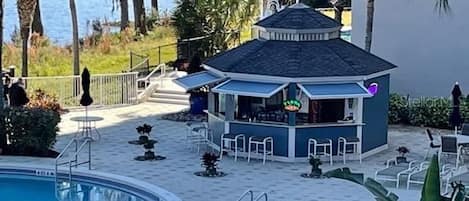 A poolside area with a small bar and seating.