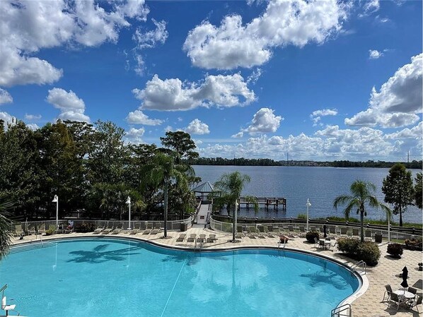 Relax by the serene pool overlooking a calm lake and enjoy the tranquil atmosphere.