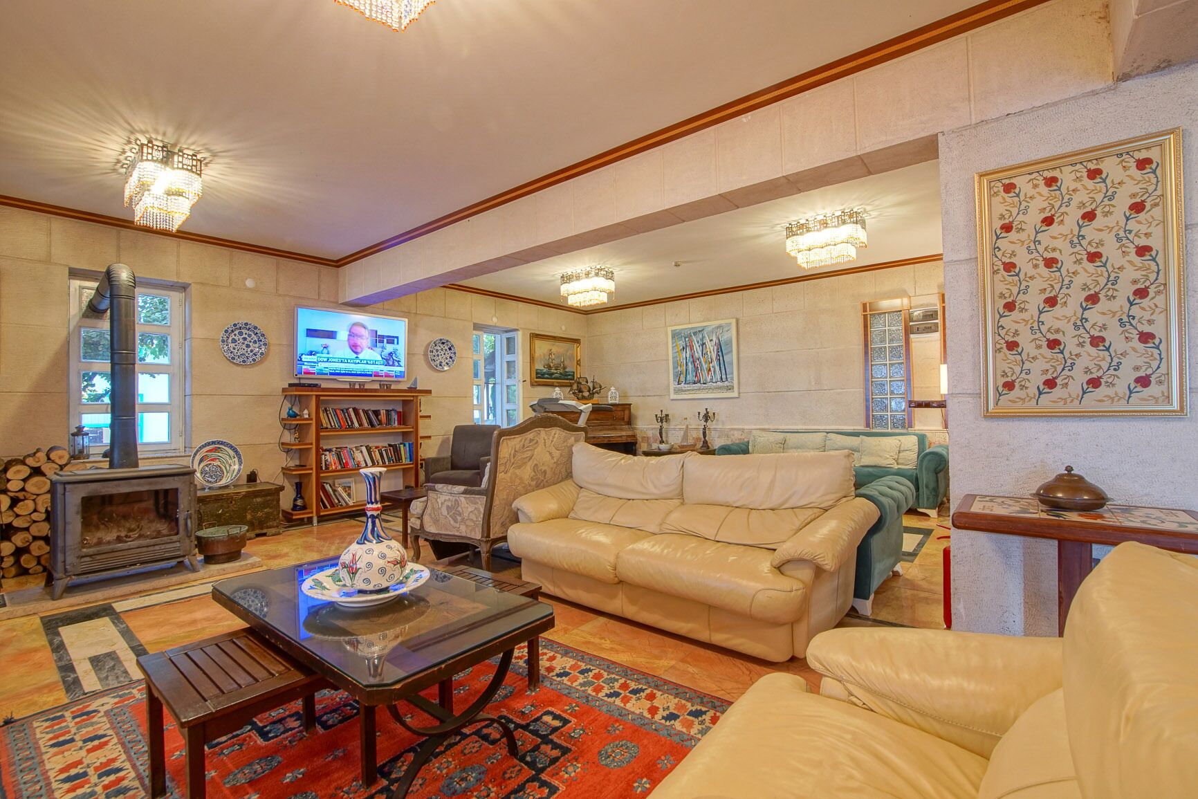 A cozy living room with a fireplace, leather sofa, and a television.