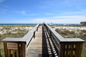 A wooden boardwalk leading to a beach with a 'No Pets Allowed' sign. - 🌴You CAN afford Paradise! Life is better at the beach. 🌊Call today! (Gulf Shores)
