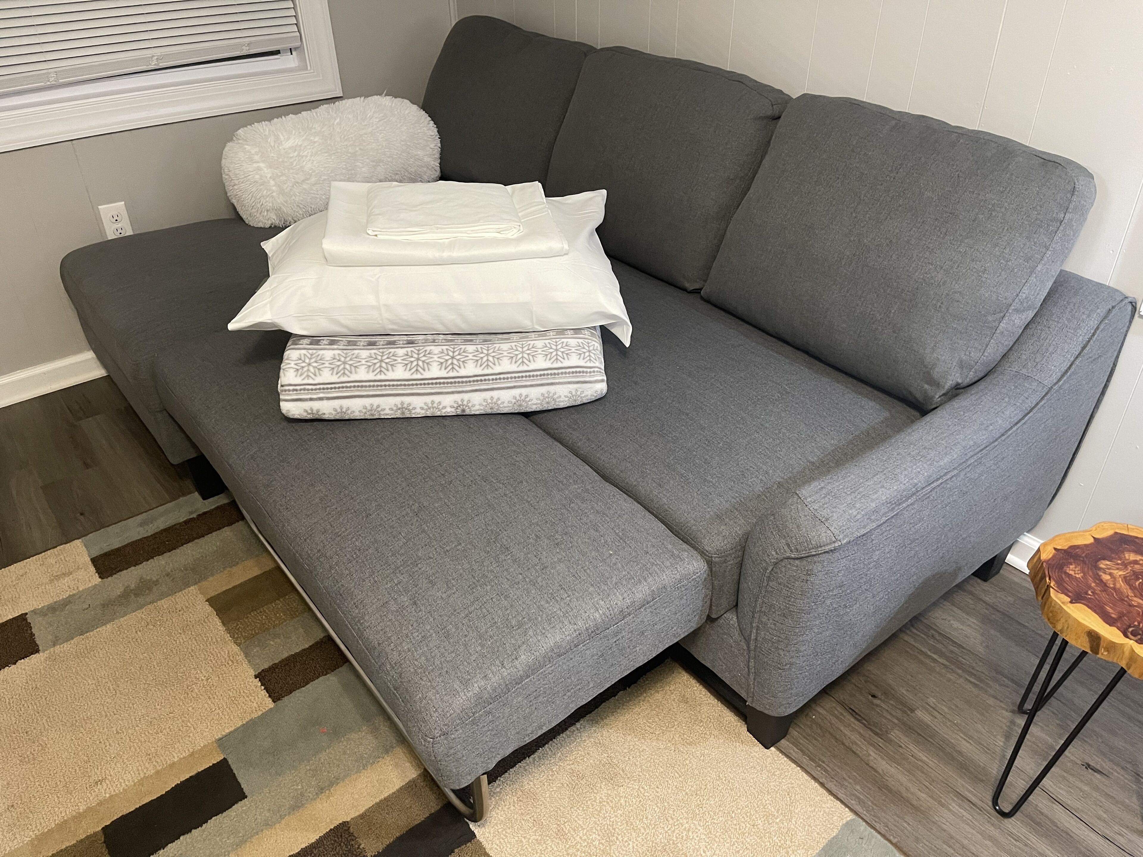 The couch in the living room unfolds into a surprisingly very comfortable bed. 