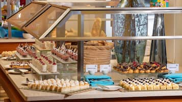 A bakery display case with various pastries and desserts.