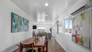 A modern kitchen with white cabinets, a grey countertop, and a window. - Rare Modern Beachfront Lake House on Lewisville Lake with Hot Tub, Deck & BEACH (Little Elm)