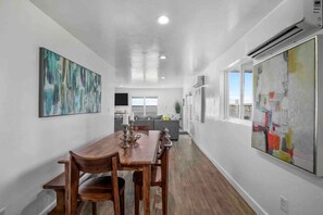 A modern kitchen with white cabinets, a grey countertop, and a window. - Rare Modern Beachfront Lake House on Lewisville Lake with Hot Tub, Deck & BEACH (Little Elm)
