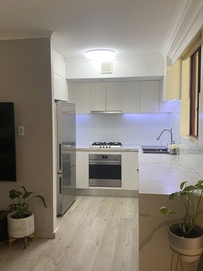 Enjoy cooking in this well-equipped kitchen with a central island, oven, and gas stove.