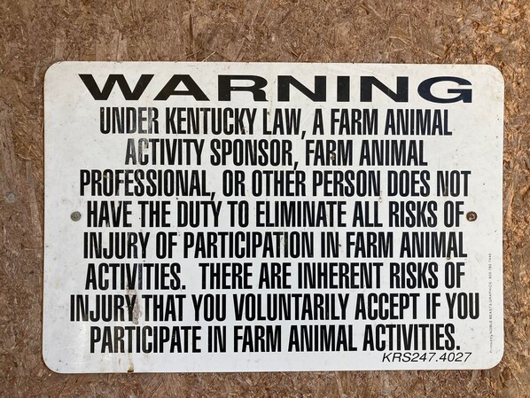 A warning sign with text regarding farm animal activities and Kentucky law. - Bluegrass Blessing - Rural house central to Ark, Creation Museum, Cincy (Walton)