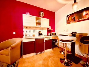 A compact kitchen with a microwave, coffee maker, and a clock on the wall. - Vip Luxurious Apartment (Medulin)