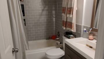 Combined shower/tub, hair dryer, towels, soap