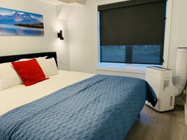 Um quarto com cama, janela e aquecedor.