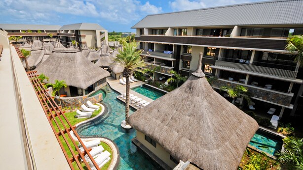 A resort with multiple buildings, a central swimming pool, and thatched-roof structures. - Apartment in Hotel Residence (Grand-Baie)
