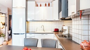 A modern kitchen with white cabinets, a sink, and a countertop. - the Cosy Modern and Comfortable Apartment in the Heart of Heraklion City Centre (Heraklion)