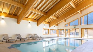 An indoor swimming pool with wooden beams and large windows. - Chalet in French Alps near Lake Geneva (Abondance)