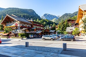 A mountain town with a hotel, a restaurant, and a view of the mountains.